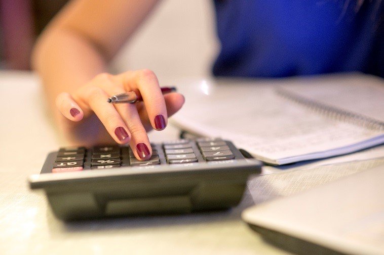 woman's fingers on calculator - do you need a bookkeeper?