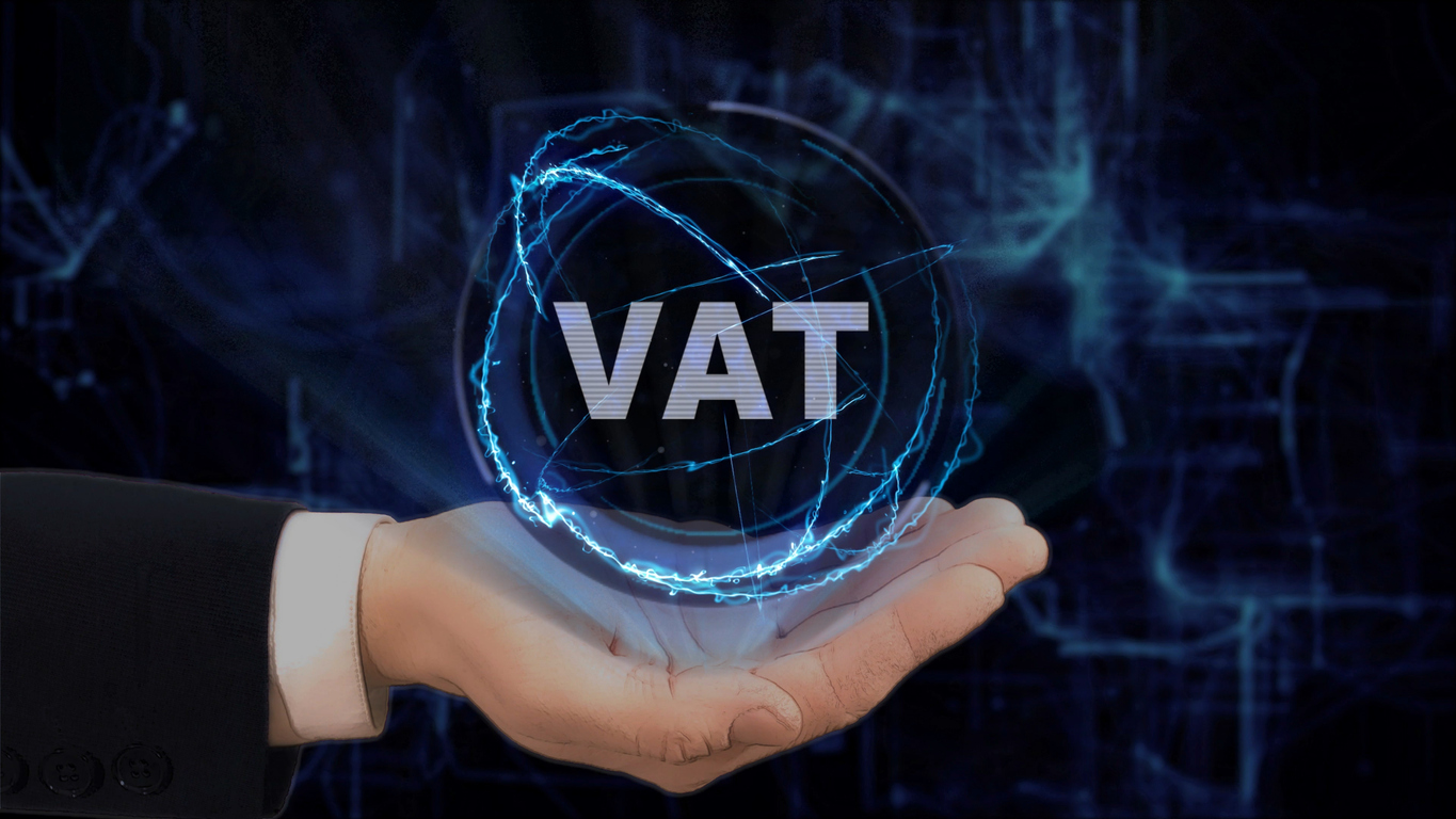 man holds floating globe with the word VAT in it