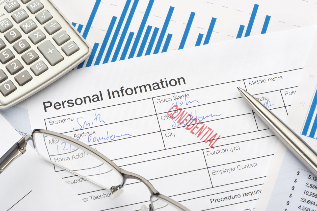 Calculator, spectacles and piece of paper saying Personal Information