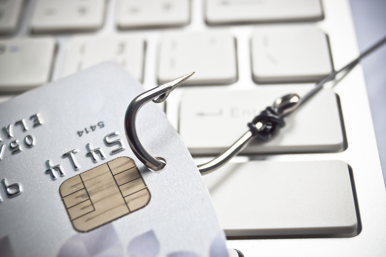 phishing scams - credit card and fishing hook on keyboard