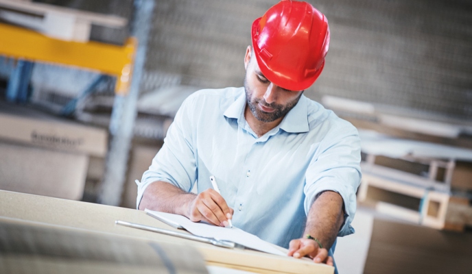 bookkeeping for construction industry - man in hard hat on building site