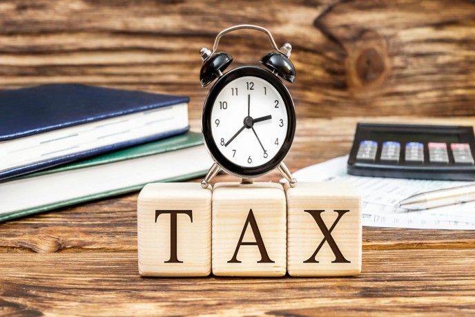 3 blocks saying TAX and alarm clock on top