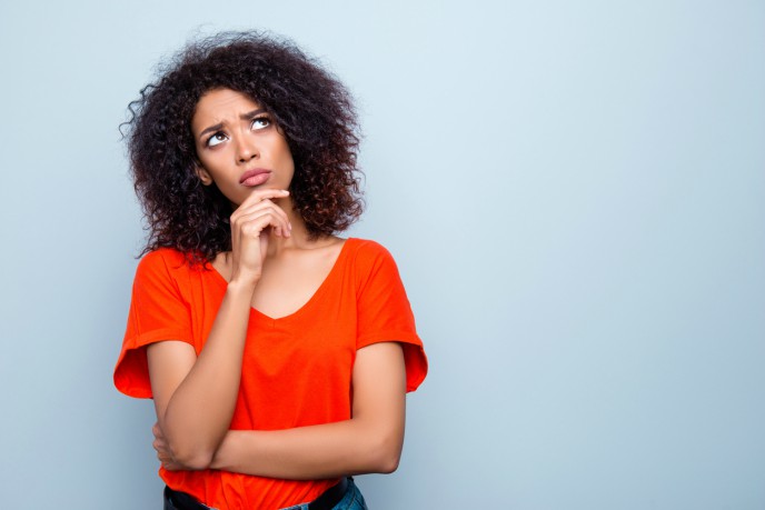 Sole trader or limited company? - woman looking thoughtful with hand on chin