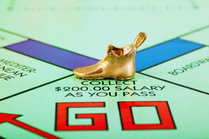 The headache of payroll – monopoly board with golden shoe game piece