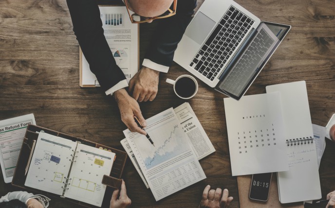 bookkeeping practices important - overhead shot of table covered in paper with graphs