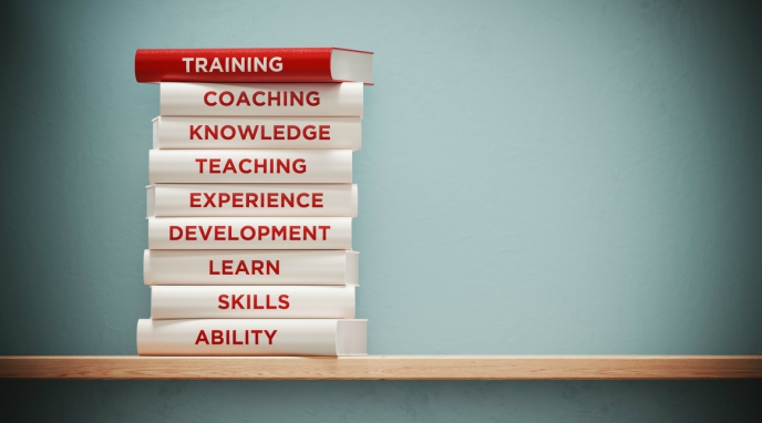 Xero Expertise - image of pile of white books with red one on top spine reads 'training'