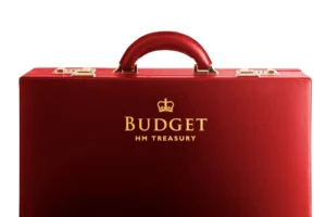 A red briefcase with ‘Budget HM Treasury’ stamped on it in gold letters