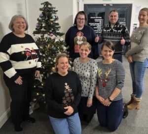 an office team in christmas jumpers