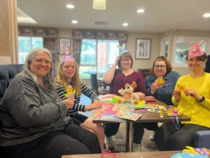 A group of women doing easter themed crafts in a carehome